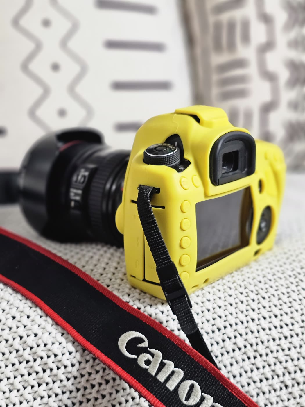 Tanya's yellow-cased Canon EOS 5D with an L-series lens and Canon strap