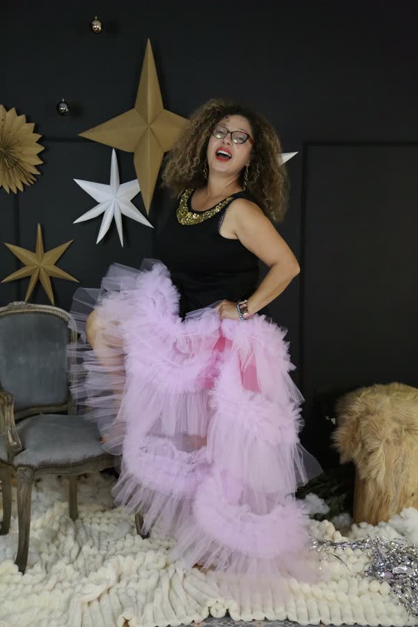 Woman in pink tulle on a star-decorated glamour set