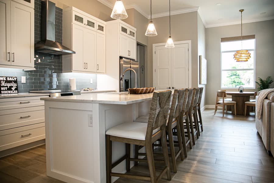 White kitchen with pendant lighting and island bar seating