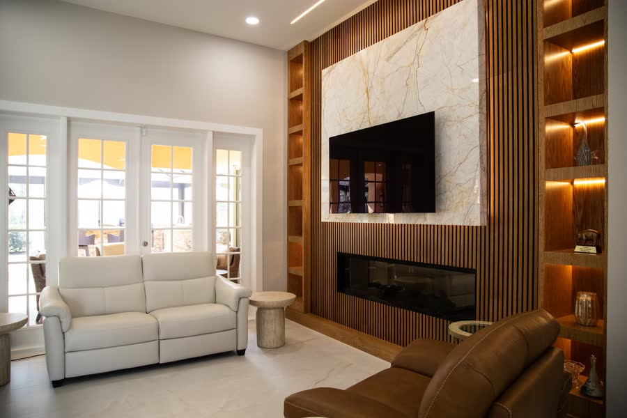 Living room with backlit wood feature wall and linear fireplace