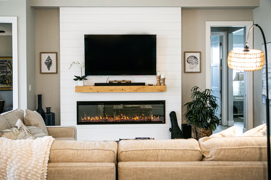 Living room with linear fireplace, mounted television and shiplap detailing