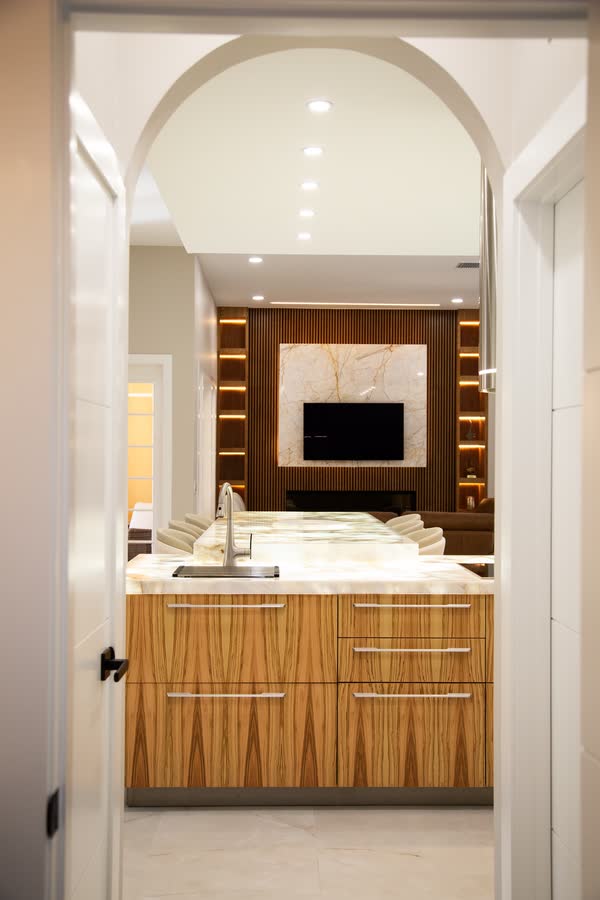 Arched hallway entry leading into a primary suite