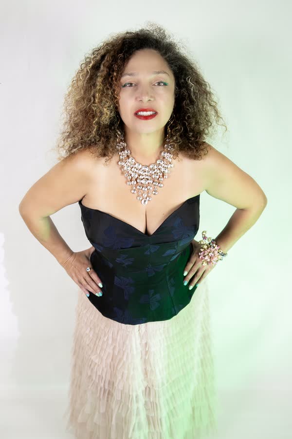 Editorial portrait of a woman in a structured corset gown