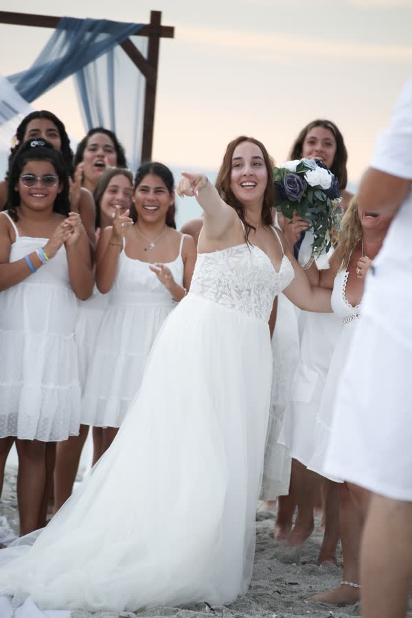Bride surrounded by her bridesmaids before the ceremony