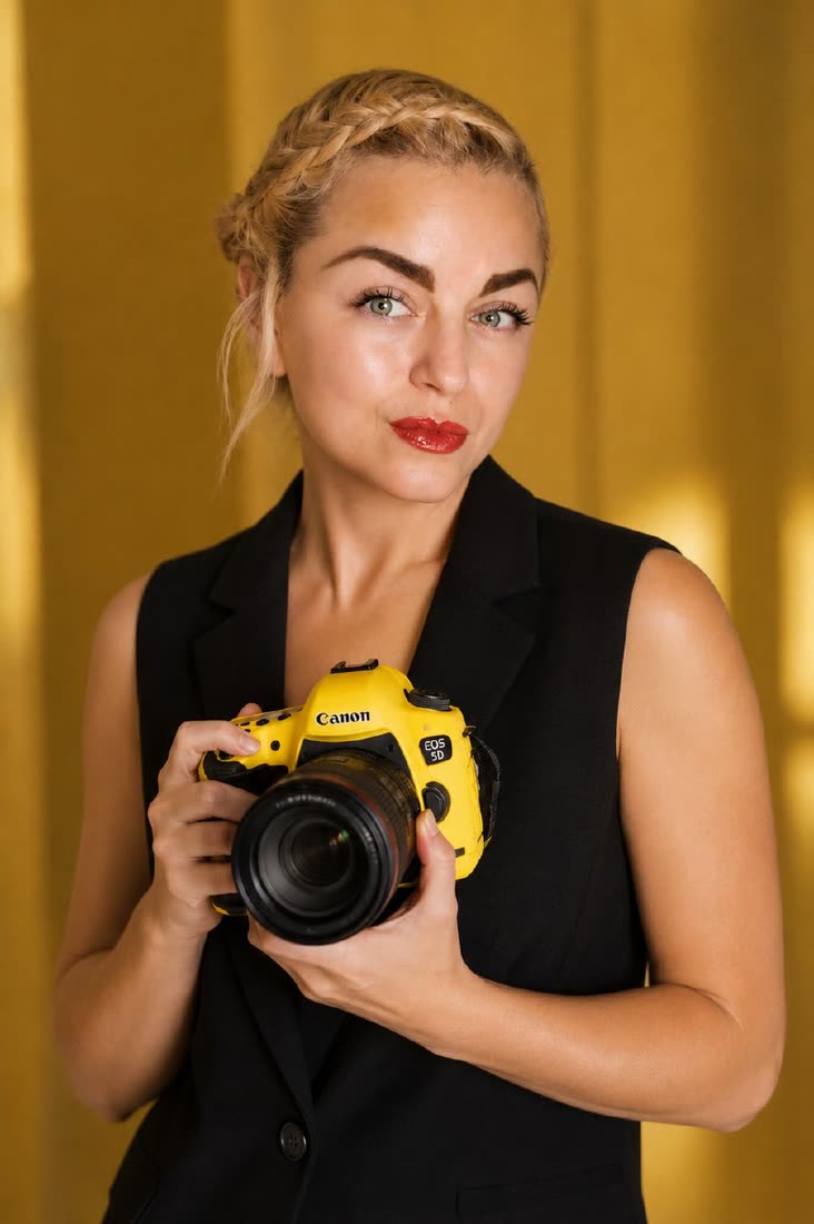 Tanya Paik, real estate photographer at Rejuveself Photography, holding her yellow Canon EOS 5D
